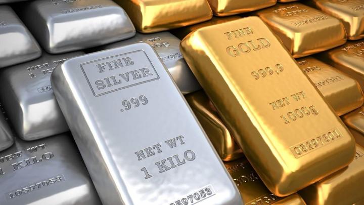 Both gold and silver traded lower on dollar strength and bullish economic data